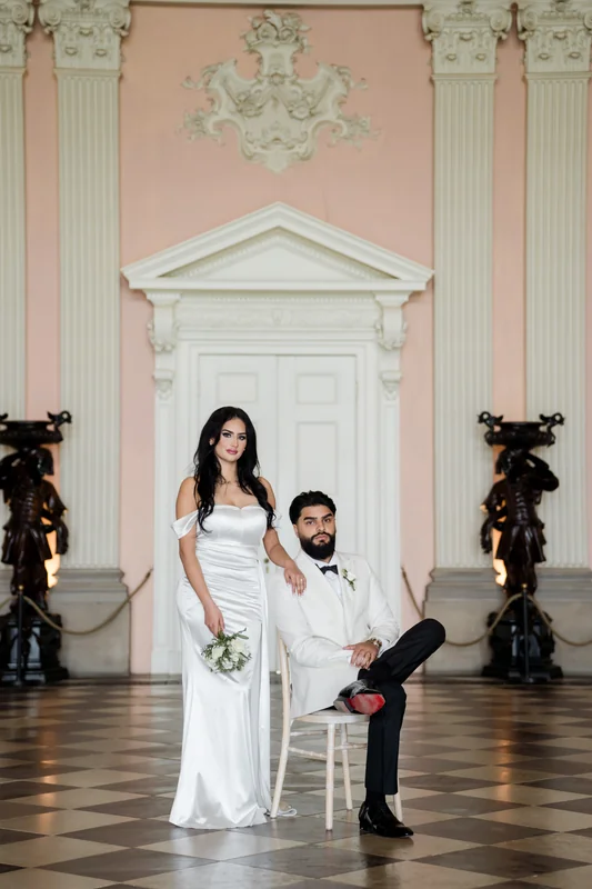 Ajay and Jessica in an ornate pink room