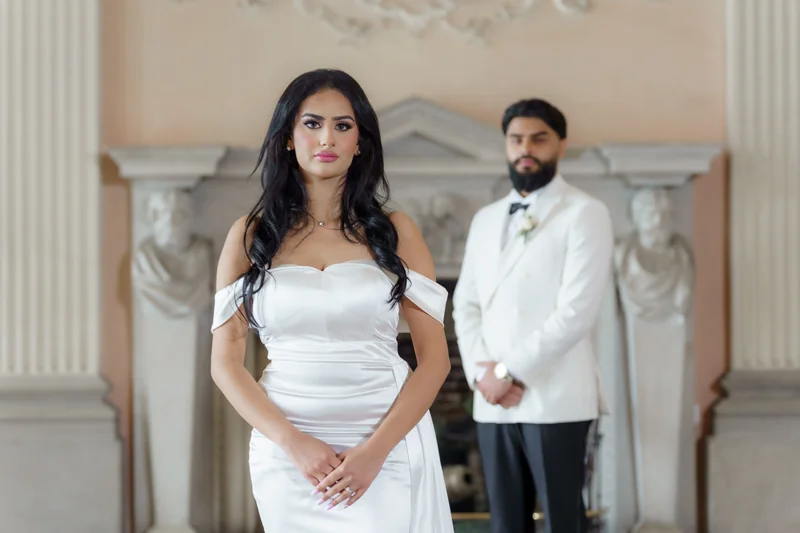 Ajay and Jessica together beside the fireplace