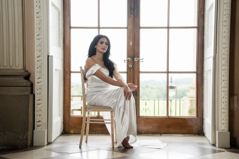 Jessica standing beside a sunlit window