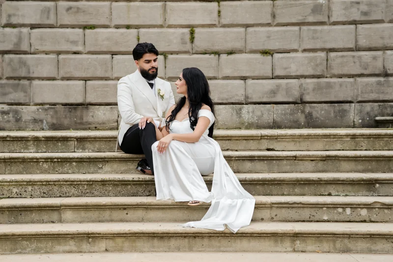 Ajay and Jessica seated together on stone steps