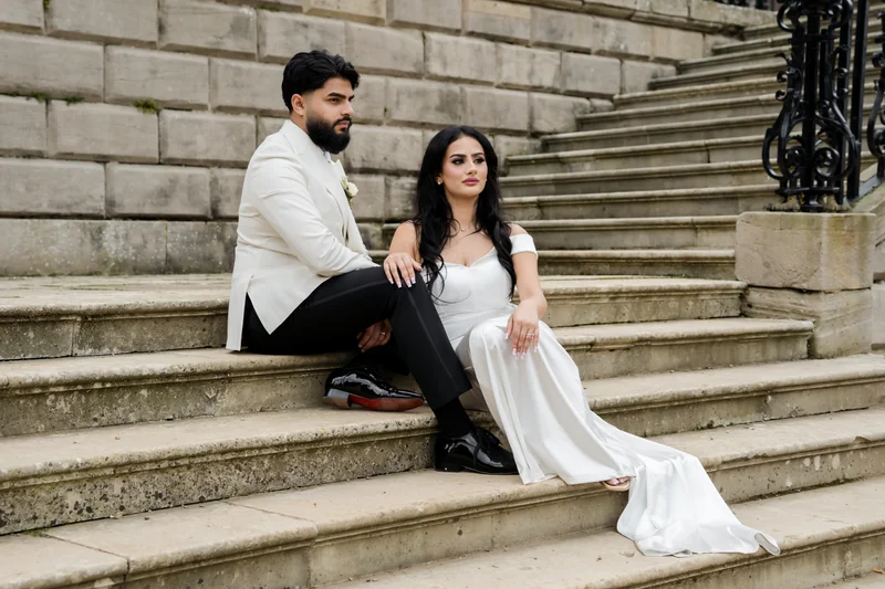 Ajay looking towards Jessica on the staircase