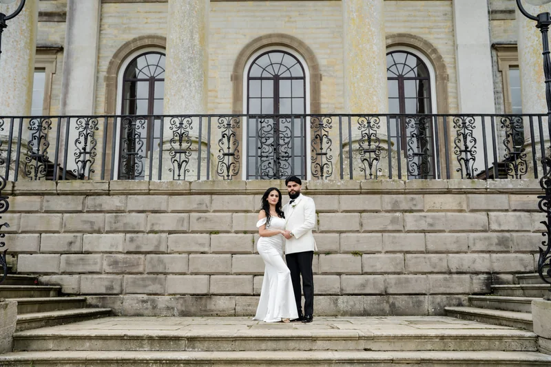 The couple on the staircase outside the grand building