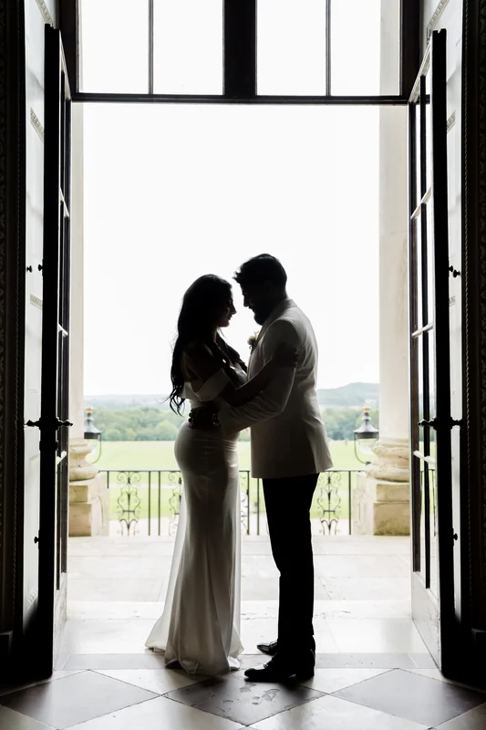 The couple silhouetted against the window