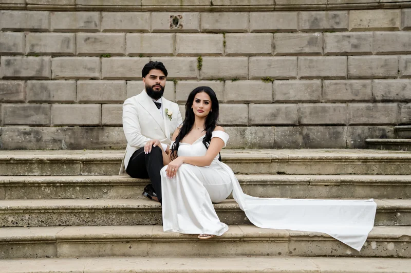 Ajay and Jessica seated on the stone staircase