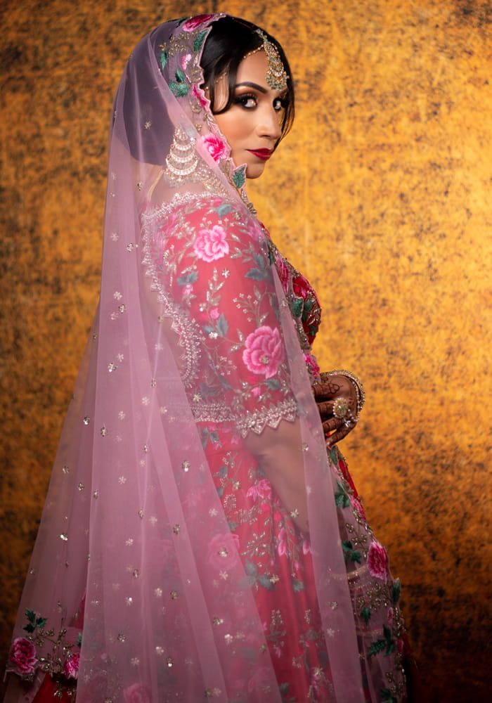 Indian bride in a floral pink wedding outfit